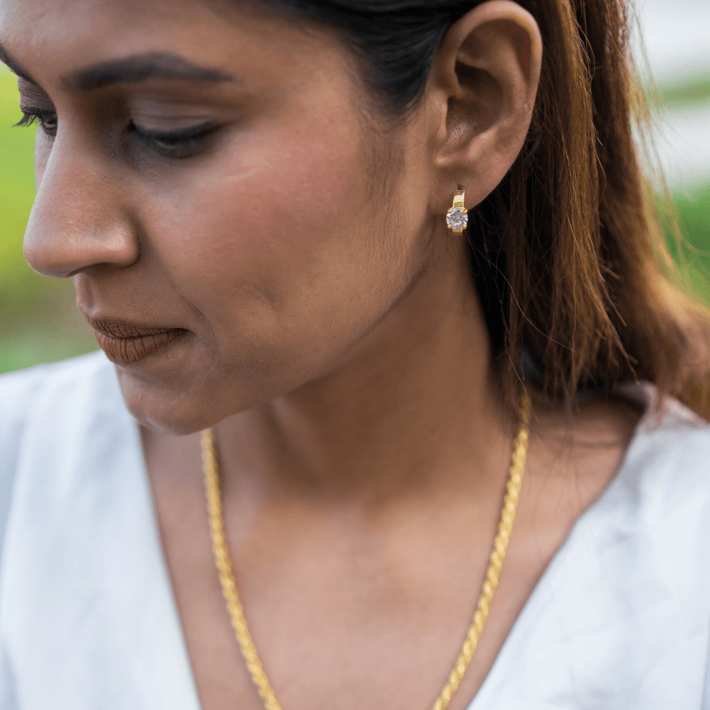 Model wearing Gold plated 925 sterling silver earrings with high grade American Diamonds