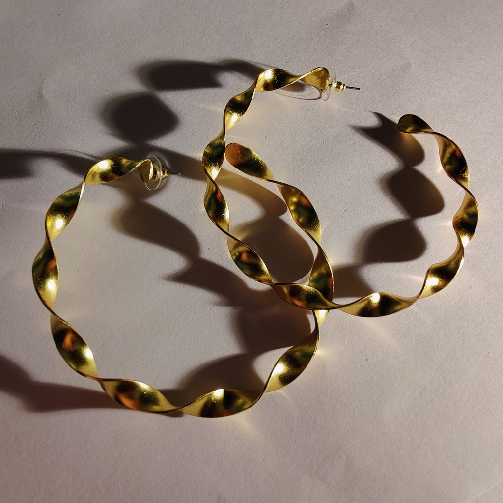 Big twirl gold hoop brass earrings. 