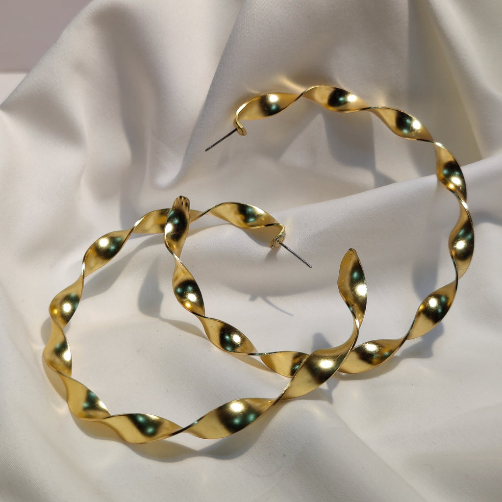 Big twirl gold hoop brass earrings. 